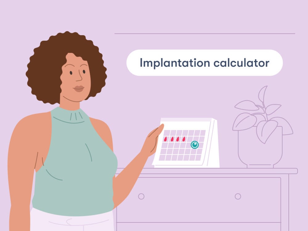 Woman holding a calendar showing her period and the date of ovulation and implantation Woman holding a calendar showing her period and the date of ovulation and implantation